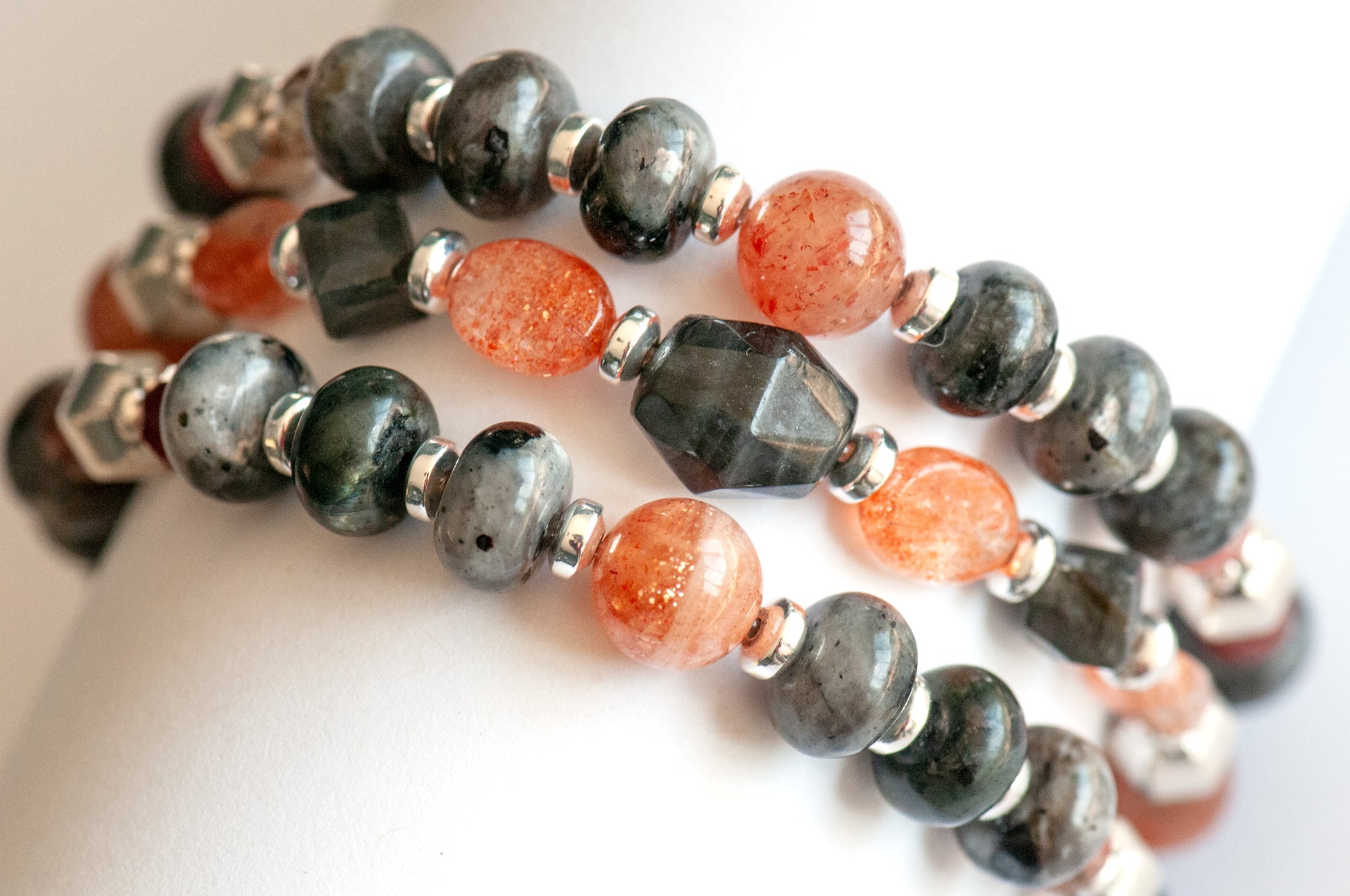 Fierce Balance bracelet set featuring hand-faceted Black Labradorite nugget, Sunstone ovals, Red Lazasine, Larvikite rondelles, and white silver Hematite spacers, part of the Fierce Friendship Collection.