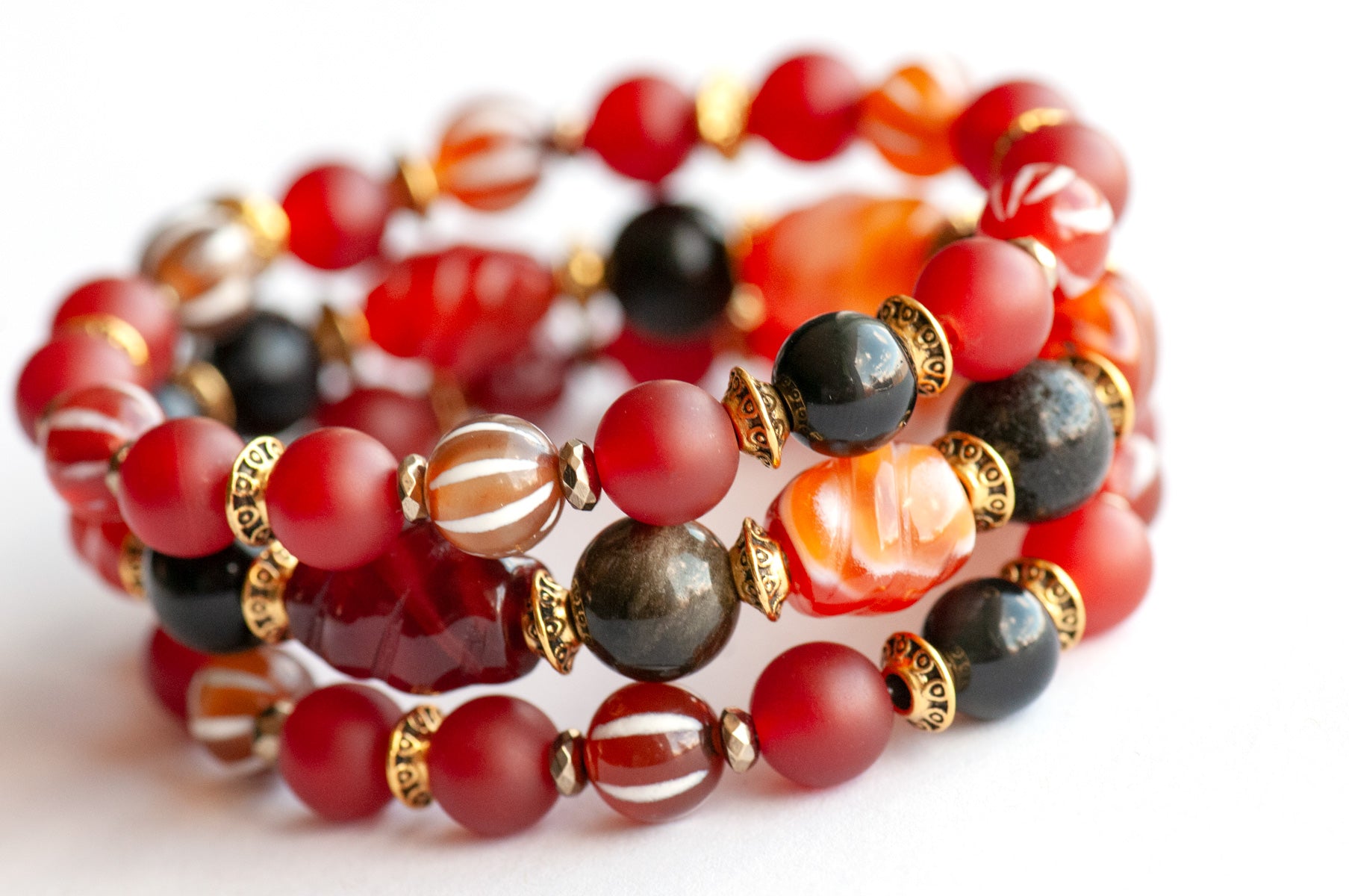 Fierce Empowerment bracelet set featuring Carnelian, Golden Obsidian, and Dzi Agate