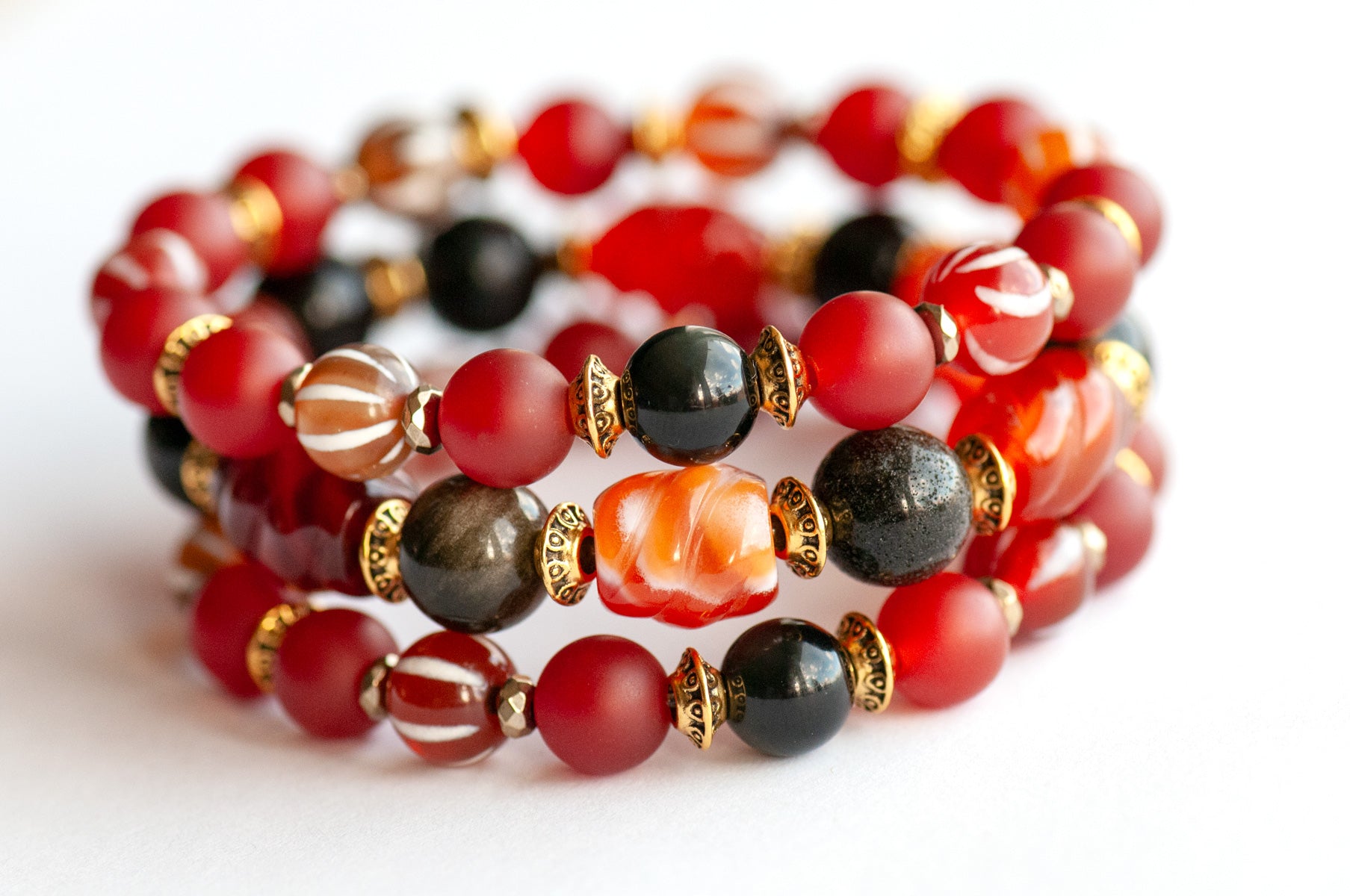 Fierce Empowerment bracelet set featuring Carnelian, Golden Obsidian, and Dzi Agate