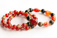 Supporting bracelets with Dzi Agate, matte Carnelian, and pyrite-plated Hematite in the Fierce Empowerment set