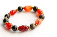 Close-up of carved Carnelian and Golden Obsidian beads in the Fierce Empowerment focal bracelet.