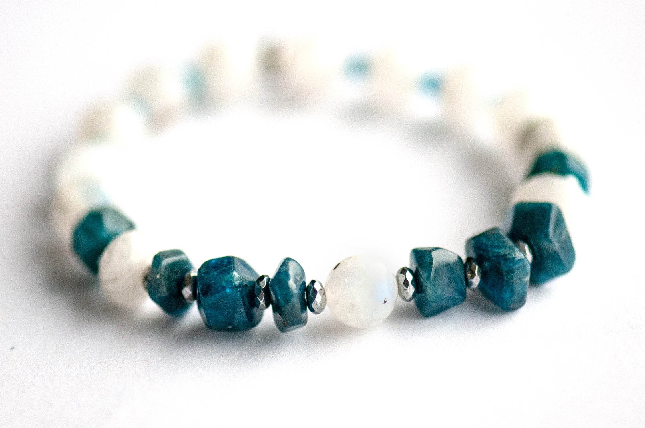 Close-up of Apatite chips and Rainbow Moonstone focal bead in the Fierce Expression bracelet.