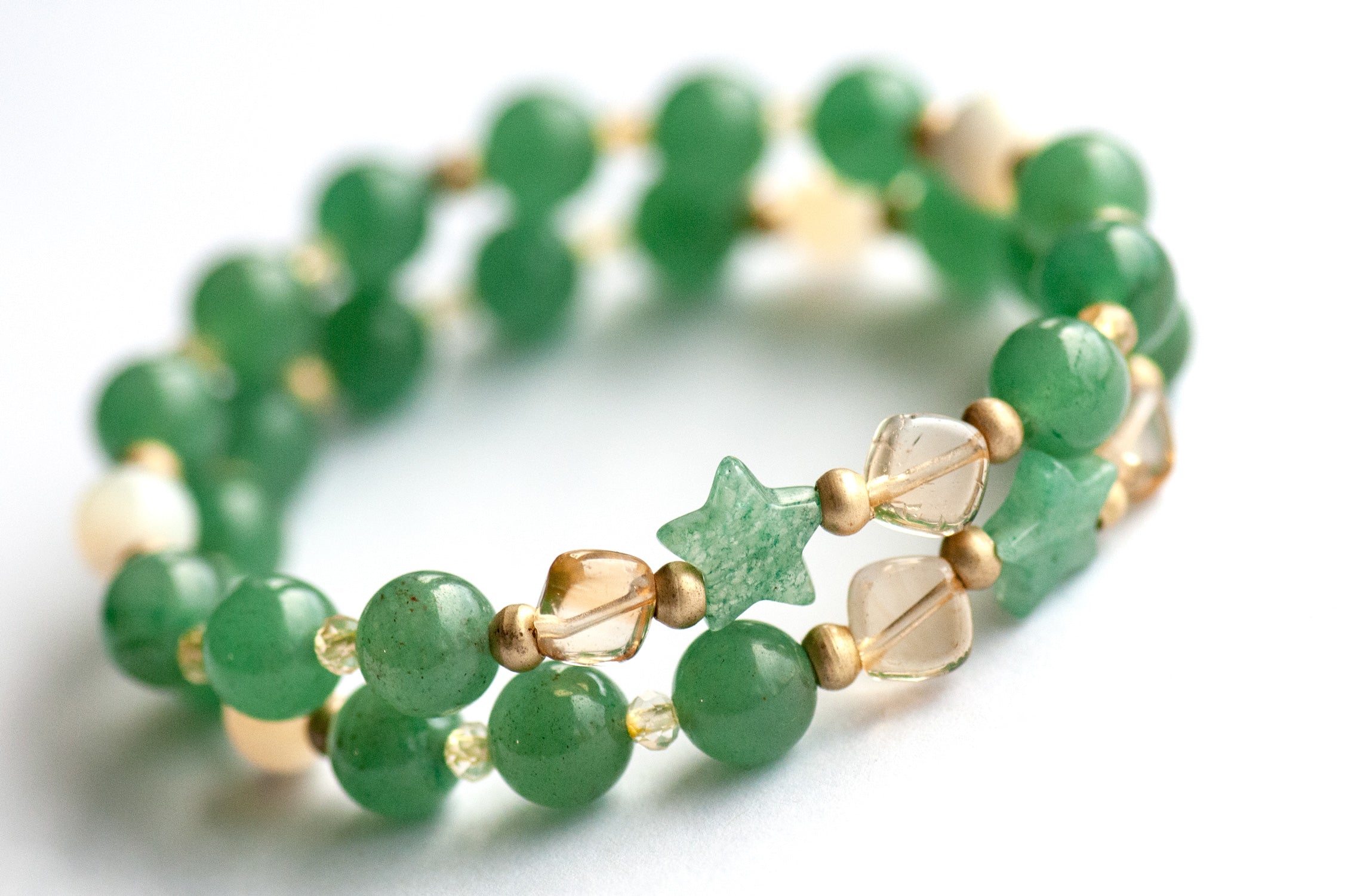 Supporting bracelets with Green Aventurine stars, Citrine accents, and brass spacers in the Fierce Joy set.