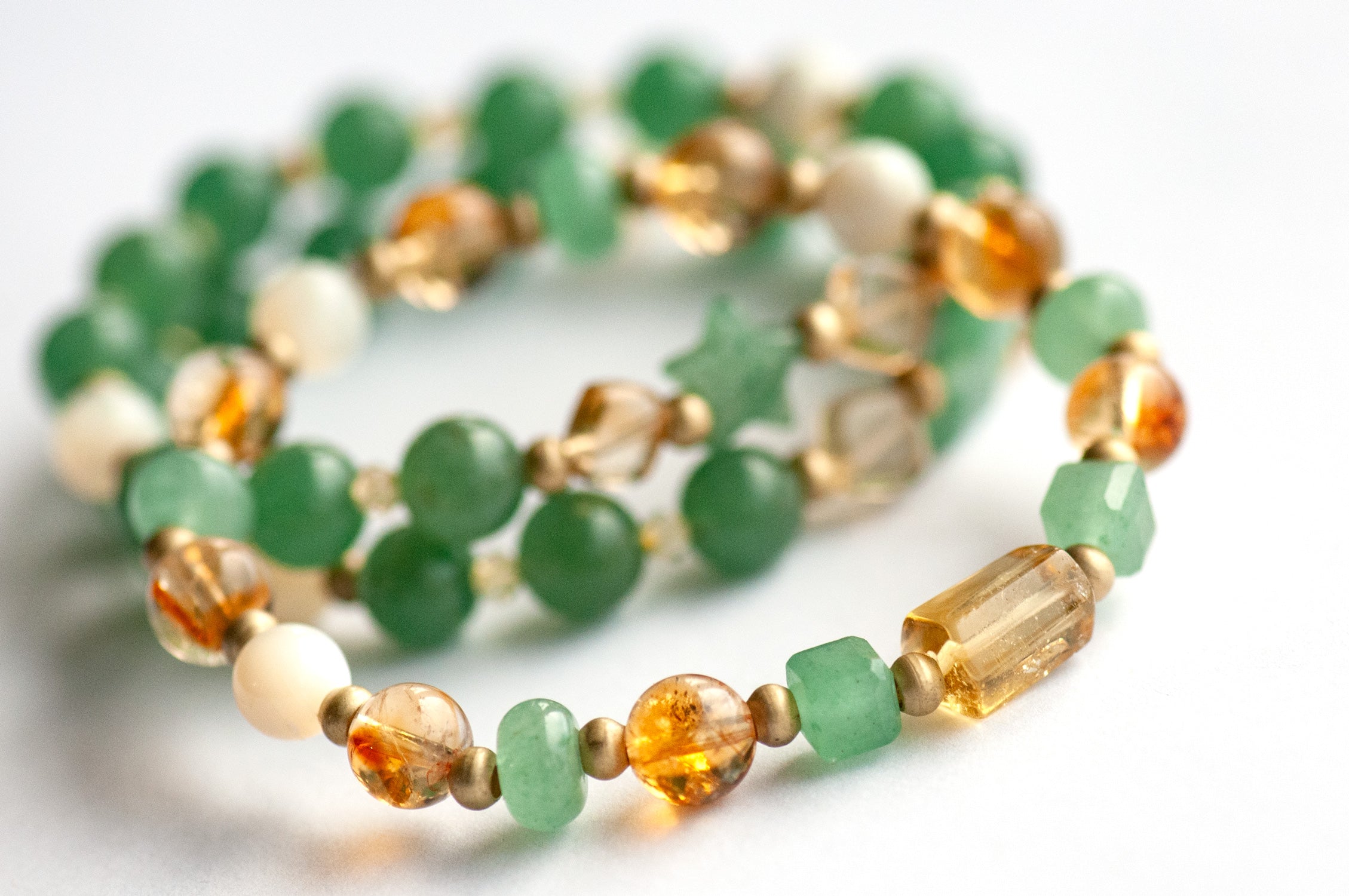 Close-up of Citrine and Green Aventurine beads in the Fierce Joy bracelet set.