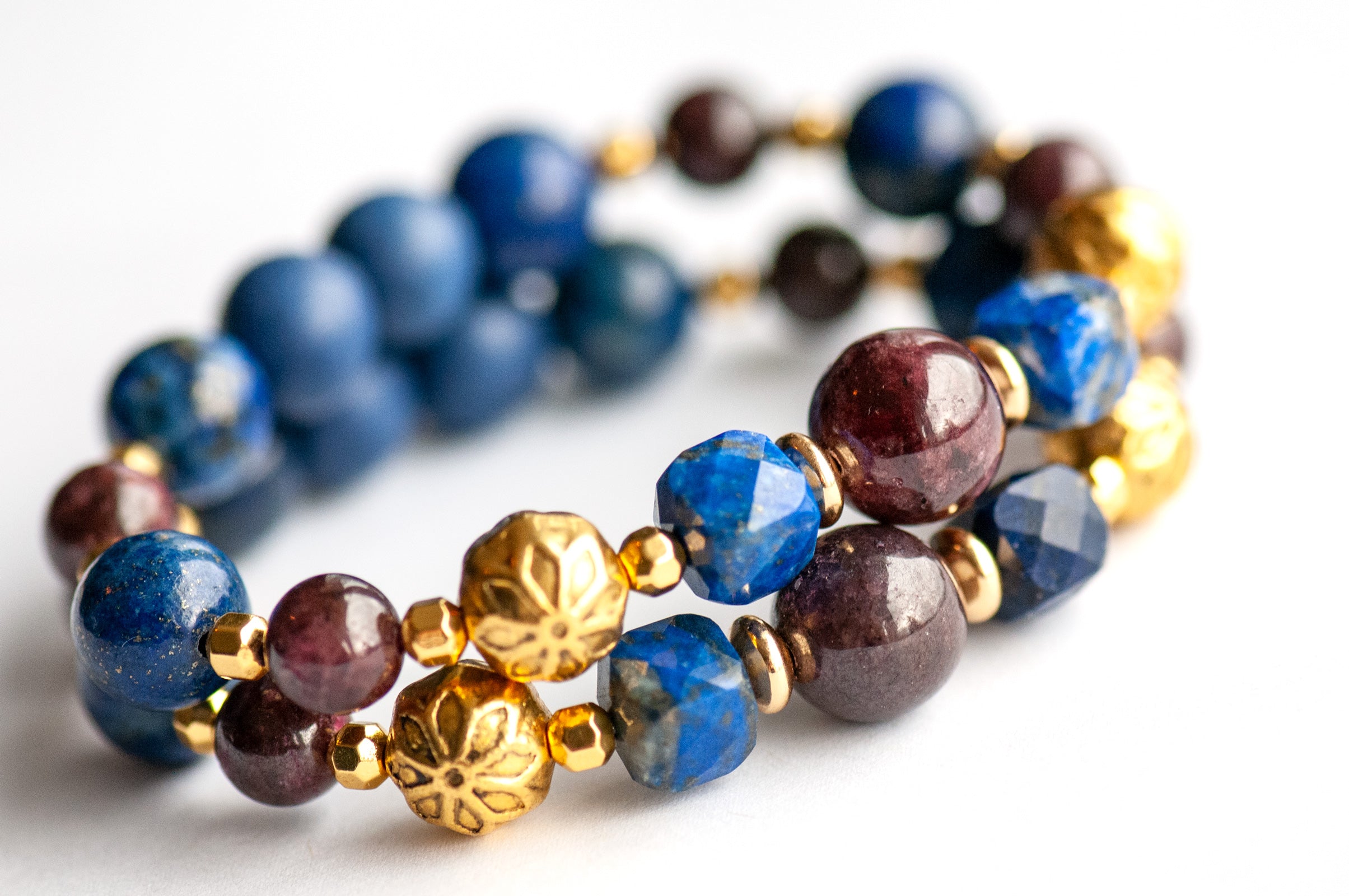 Close-up of Garnet and faceted Lapis Lazuli cubes in the Festive Lynx supporting bracelets.