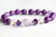 Close-up of faceted Amethyst chips and carved crystal Quartz beads in the Fierce Patience focal bracelet.