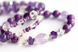 Close-up of faceted Amethyst chips and carved crystal Quartz beads in the Fierce Patience focal bracelet.