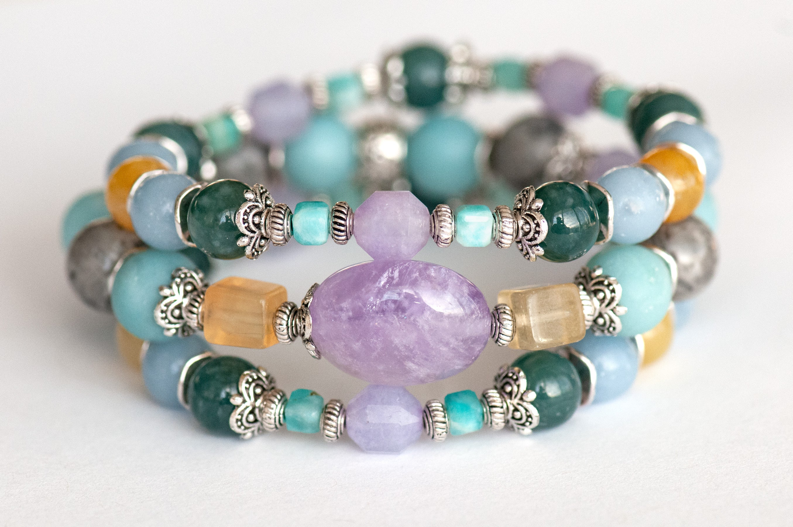 Impressionist Lynx bracelet set featuring lavender amethyst, yellow fluorite, Guatemalan jade, angelite, and amazonite, displayed in a soft, pastel colour palette.
