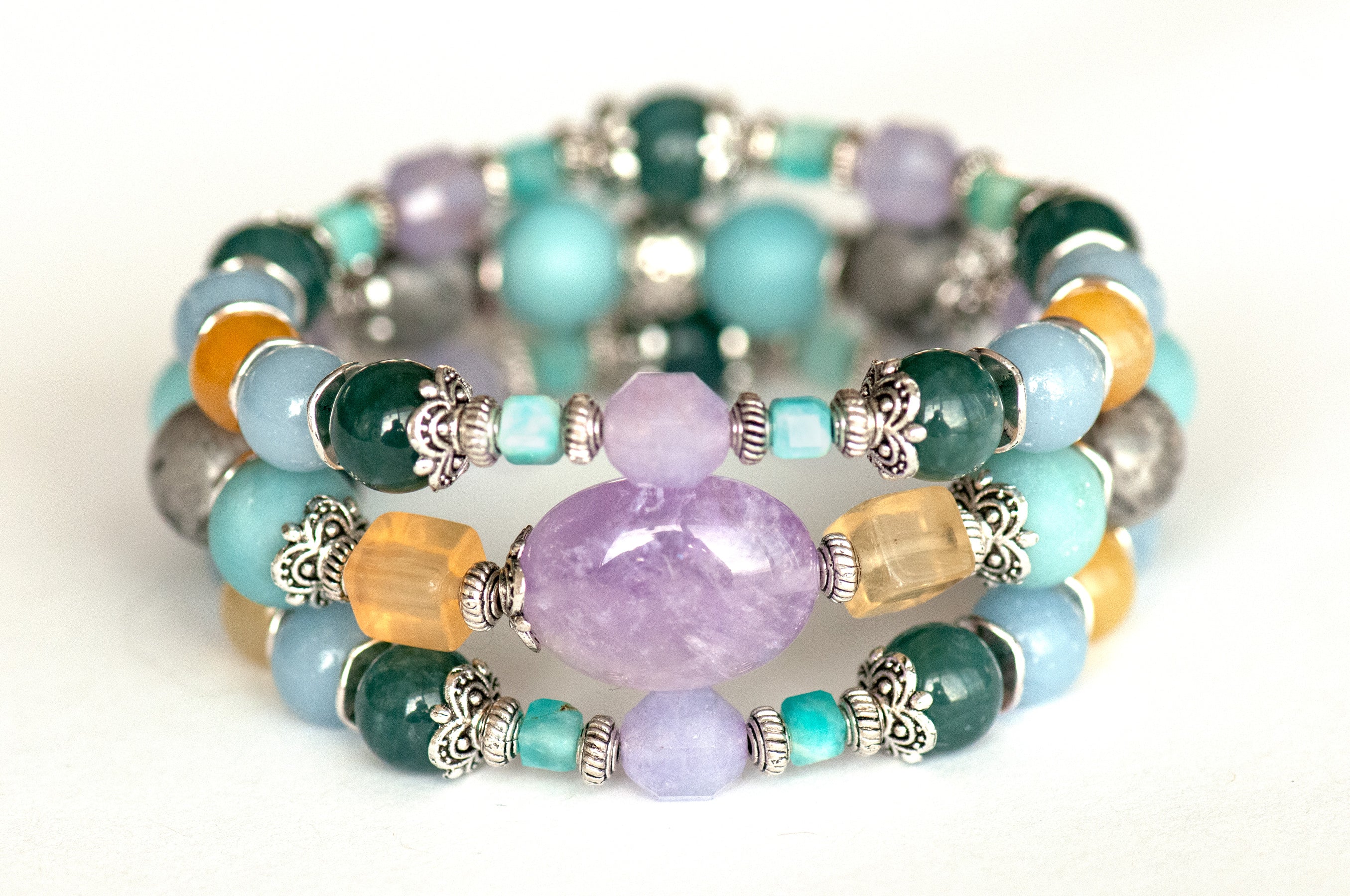 Impressionist Lynx bracelet set featuring lavender amethyst, yellow fluorite, Guatemalan jade, angelite, and amazonite, displayed in a soft, pastel colour palette.