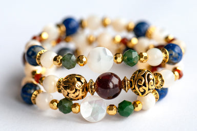 Baroque Lynx gemstone bracelet set stacked together showcasing rich jewel tones, creamy pearls, and golden accents in a Baroque-inspired design