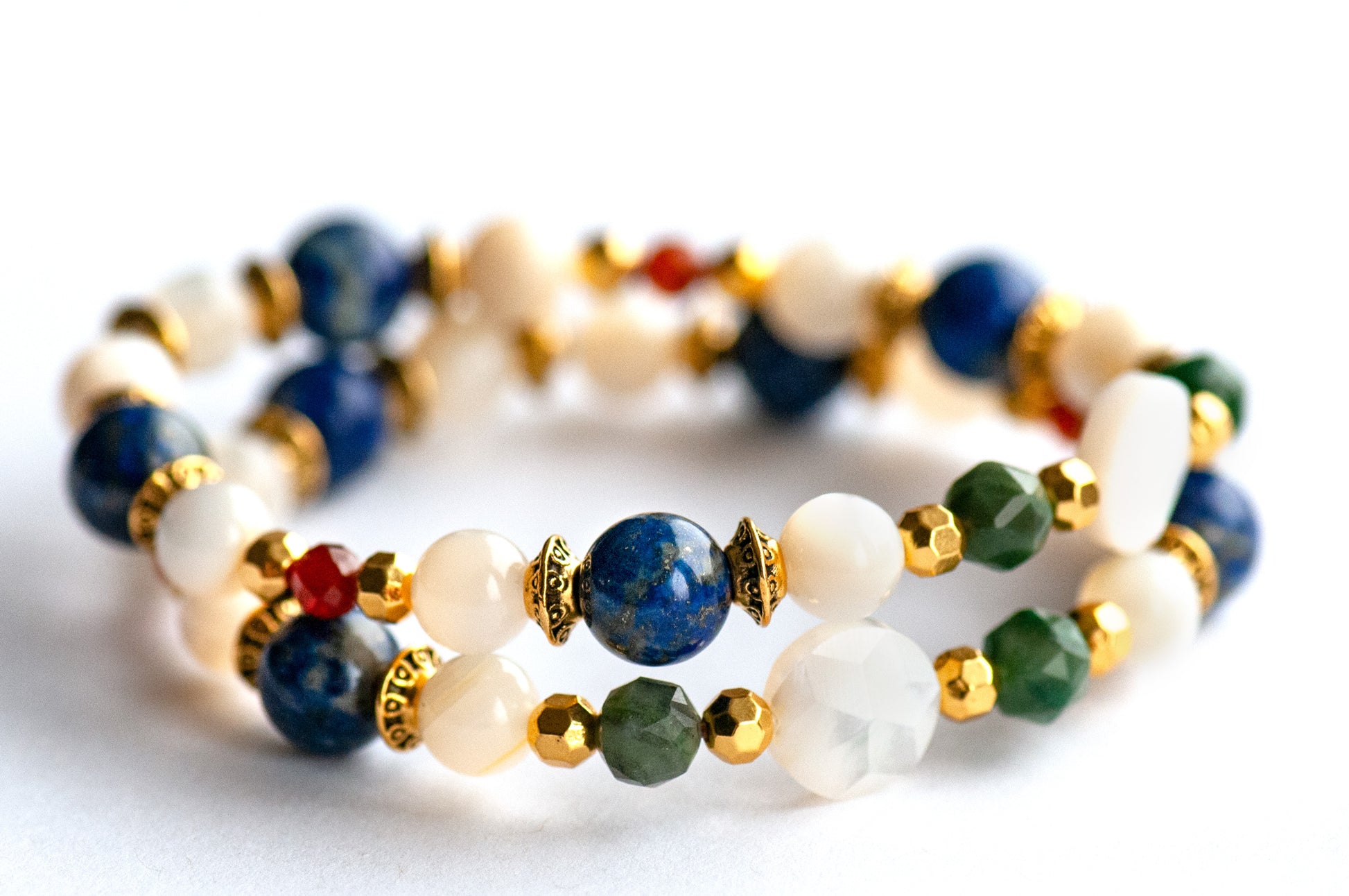 Baroque Lynx supporting bracelets with Mother of Pearl focal beads, faceted Verdite rounds, Lapis Lazuli, and gold accents