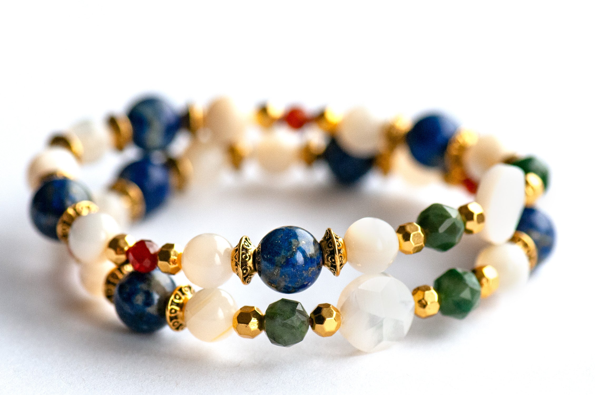 Baroque Lynx supporting bracelets with Mother of Pearl focal beads, faceted Verdite rounds, Lapis Lazuli, and gold accents