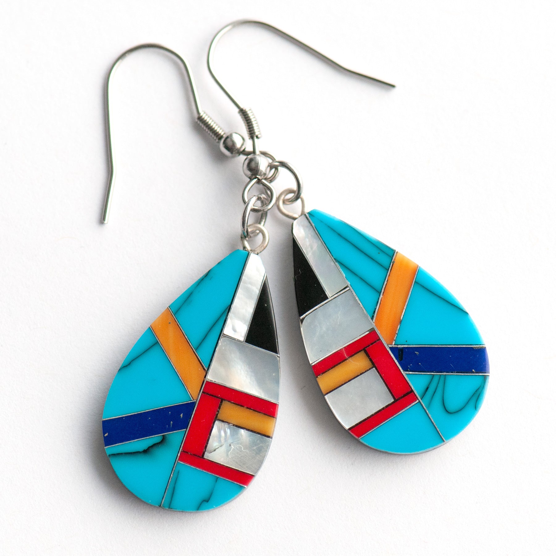 Turquoise & Pearl Teardrop Earrings featuring authentic turquoise, red and orange coral, and creamy Mother of Pearl in a black resin teardrop design.