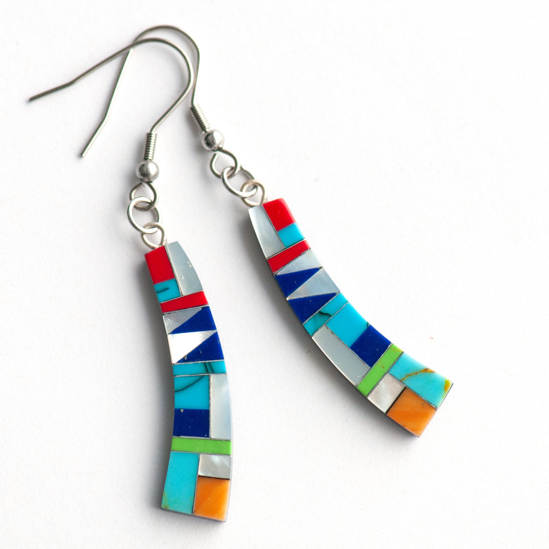 Turquoise Mosaic Curve Earrings featuring turquoise, coral, Mother of Pearl, and green and navy stones in a black resin curved rectangular design