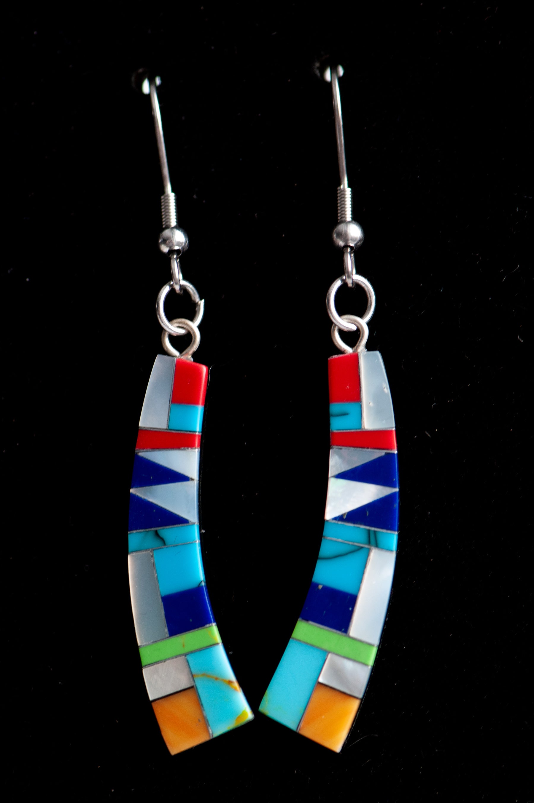Turquoise Mosaic Curve Earrings featuring turquoise, coral, Mother of Pearl, and green and navy stones in a black resin curved rectangular design