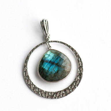 Moonlit Lynx Labradorite pendant featuring a pear-shaped stone in a silver bezel with a hammered silver ring and plated bail.