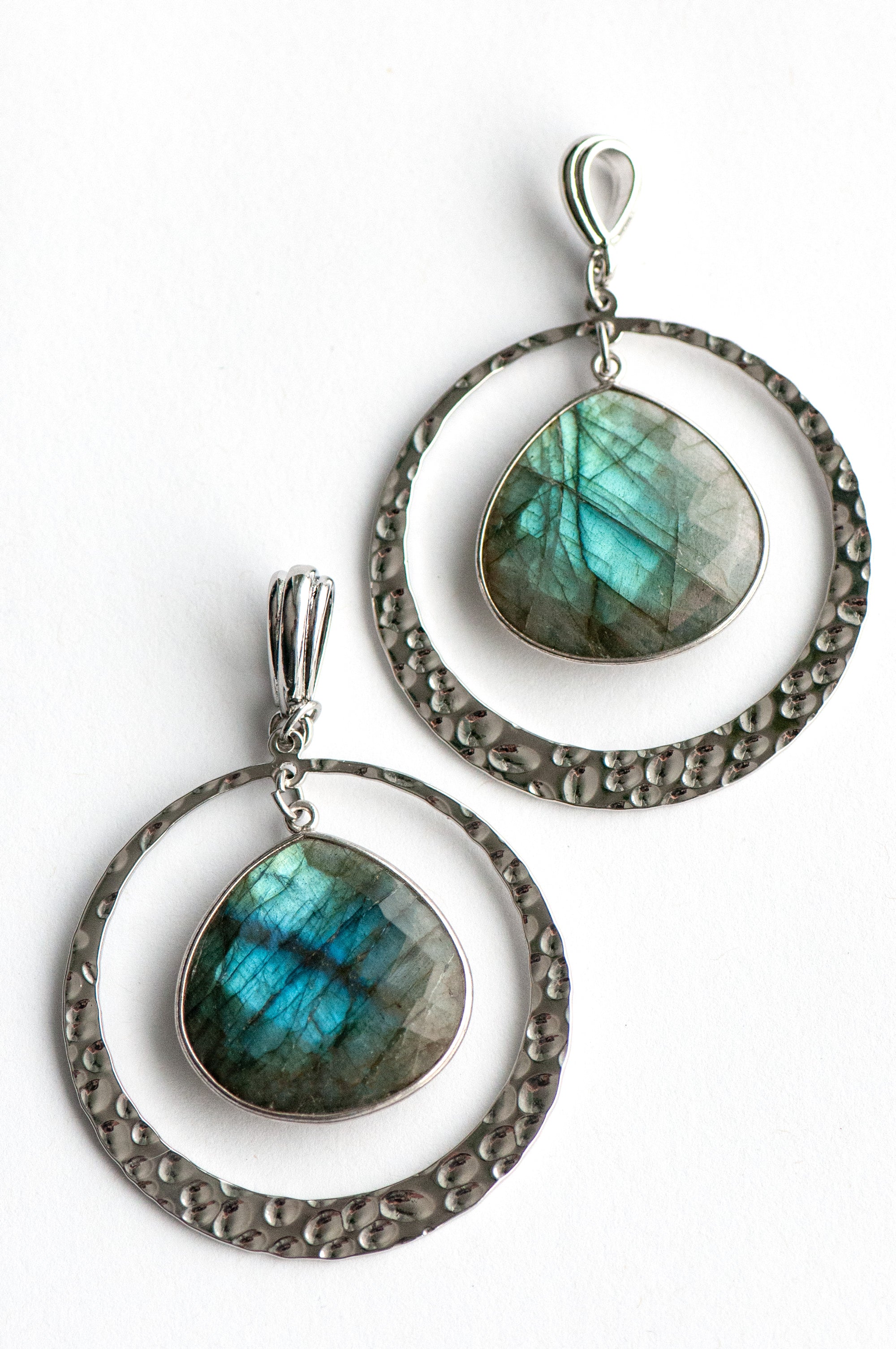 Moonlit Lynx Labradorite pendant featuring a pear-shaped stone in a silver bezel with a hammered silver ring and plated bail.