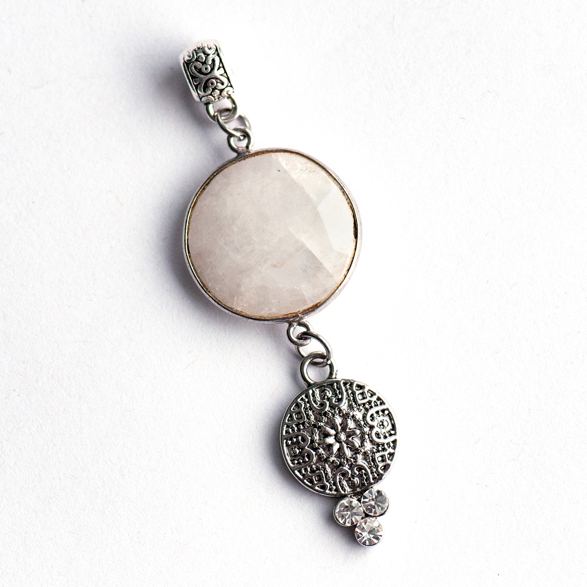 Luxe Lunar Lynx pendant featuring a faceted Blue Moonstone with a blue flash, paired with three rhinestone crystals and a silver-plated bail.