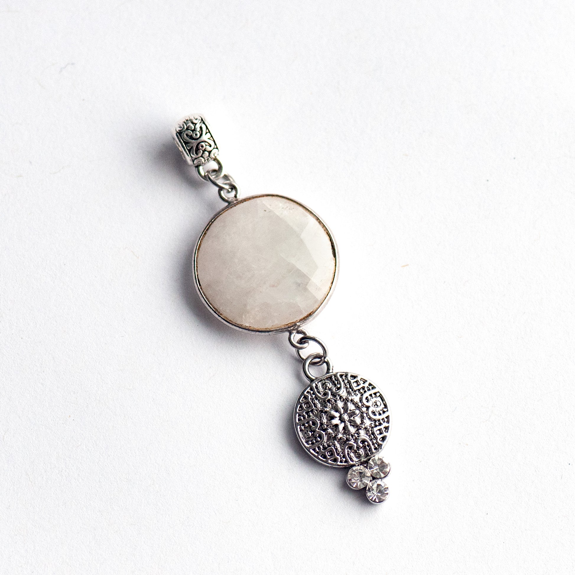 Luxe Lunar Lynx pendant featuring a faceted Blue Moonstone with a blue flash, paired with three rhinestone crystals and a silver-plated bail.