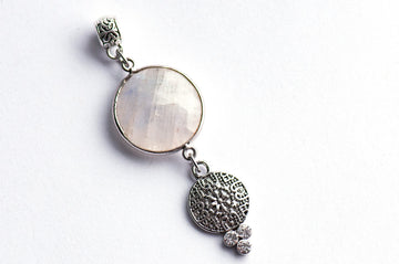 Luxe Lunar Lynx pendant featuring a faceted Blue Moonstone with a blue flash, paired with three rhinestone crystals and a silver-plated bail.