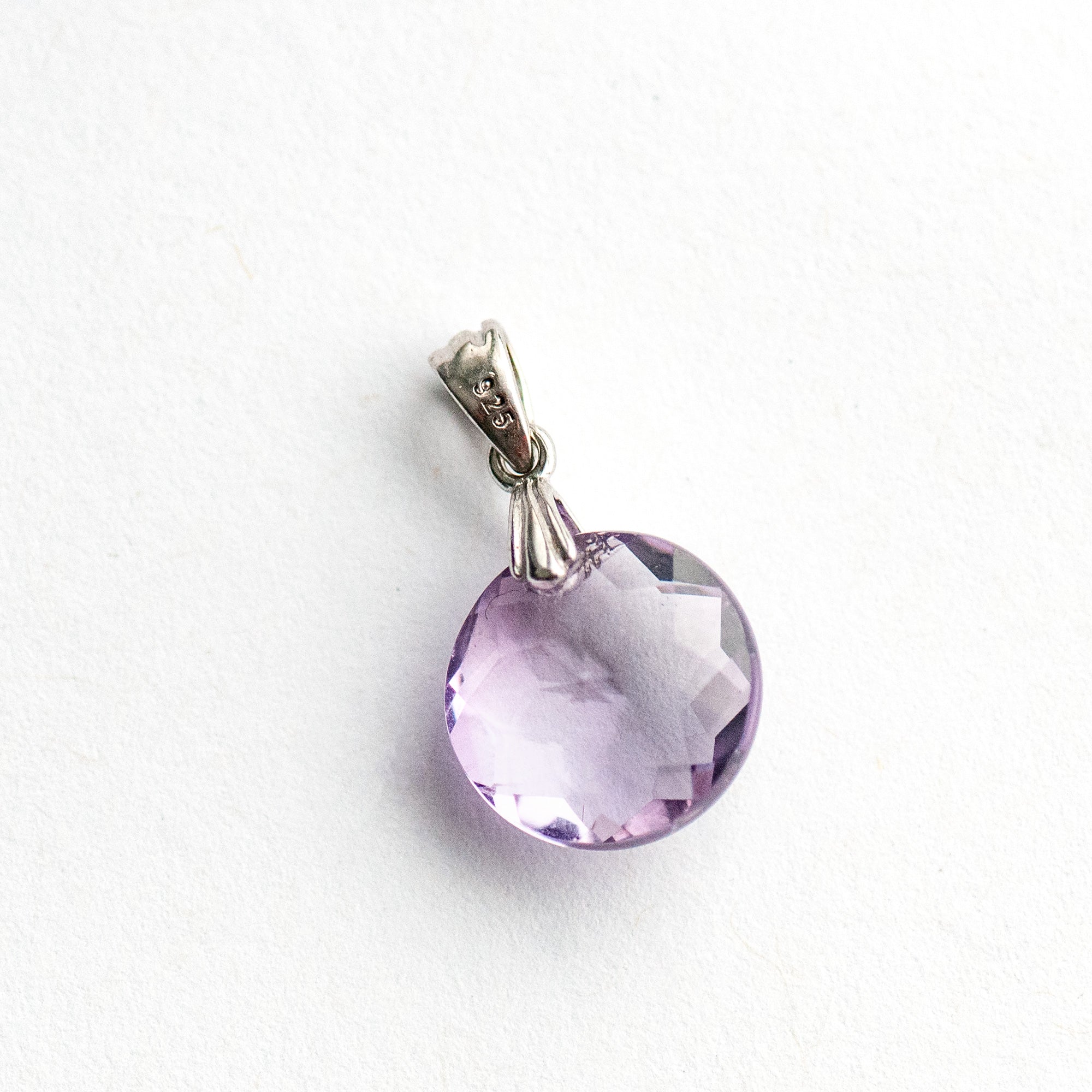 Amethyst Star Lynx pendant featuring a 12mm Amethyst coin with a starburst facet pattern and sterling silver bail.