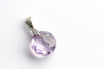 Amethyst Star Lynx pendant featuring a 12mm Amethyst coin with a starburst facet pattern and sterling silver bail.