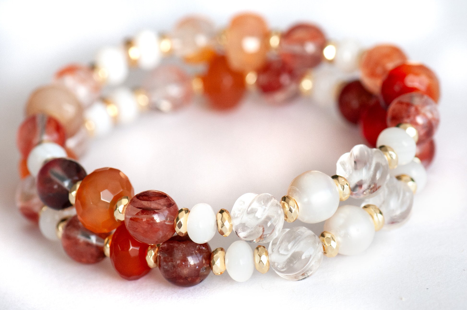Supporting bracelet with freshwater pearls and spiral-carved crystal quartz beads.