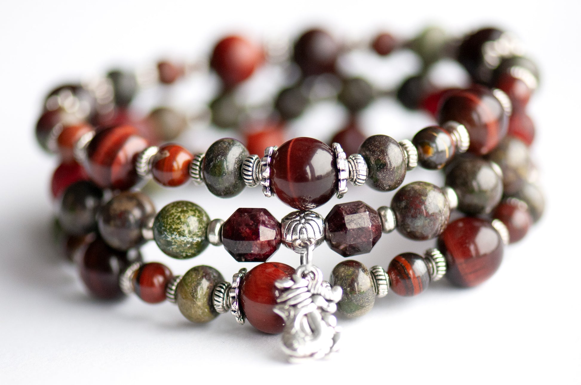 Flameborne Dragon bracelet set with Dragonblood Jasper, Garnet, Red Tiger Eye, Tiger Iron, and dragon charm – handcrafted by Fierce Lynx Designs