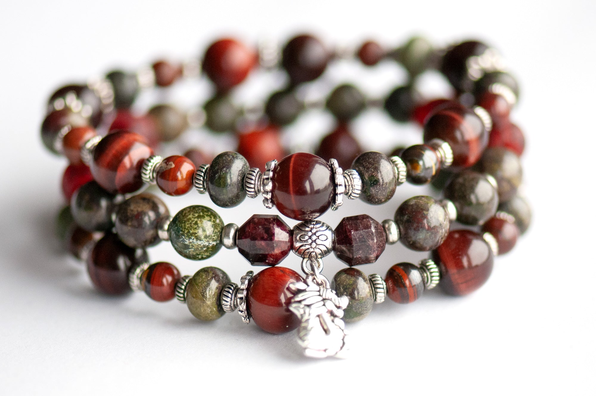 Flameborne Dragon bracelet set with Dragonblood Jasper, Garnet, Red Tiger Eye, Tiger Iron, and dragon charm – handcrafted by Fierce Lynx Designs