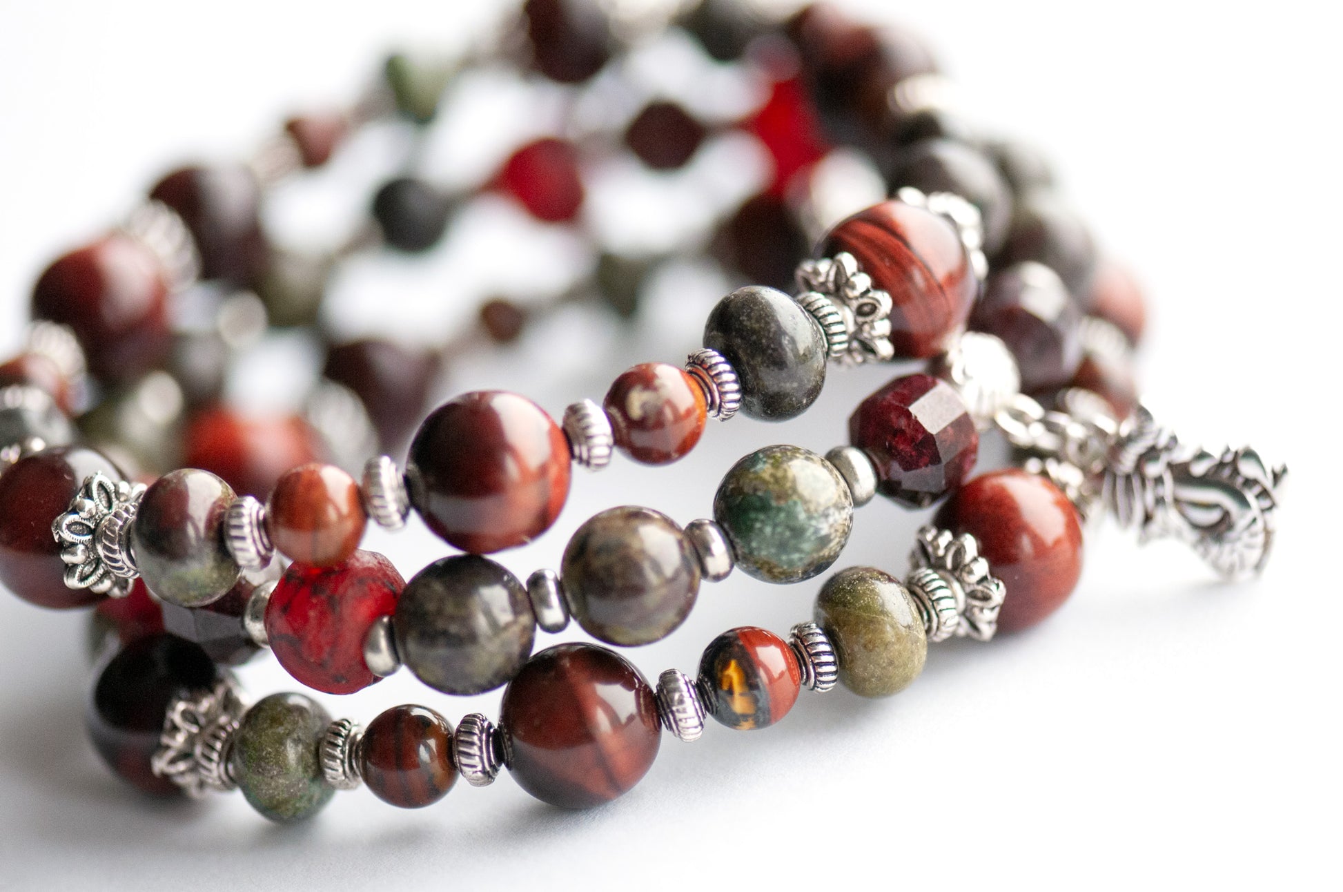Flameborne Dragon bracelet set with Dragonblood Jasper, Garnet, Red Tiger Eye, Tiger Iron, and dragon charm – handcrafted by Fierce Lynx Designs