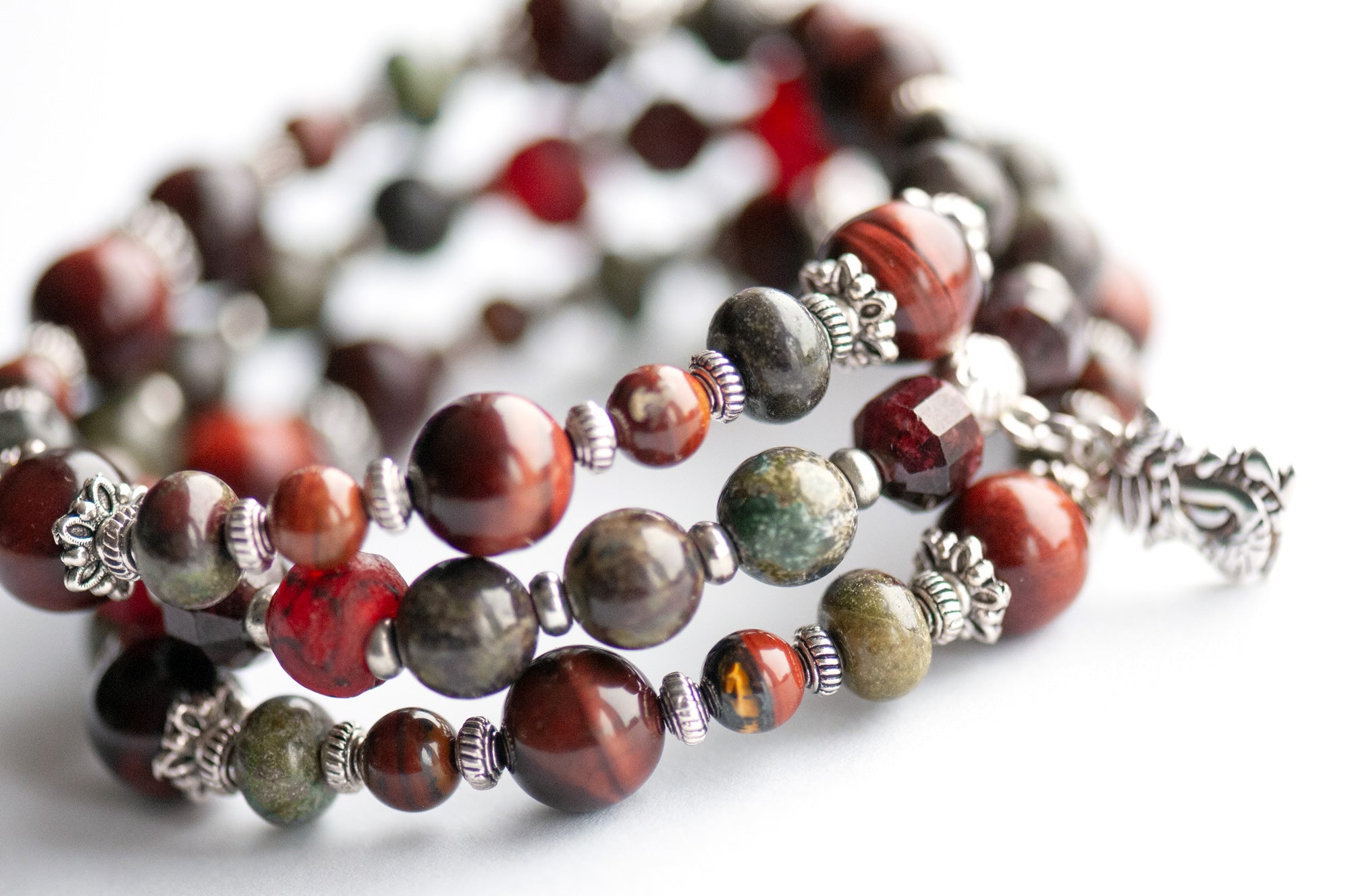 Flameborne Dragon bracelet set with Dragonblood Jasper, Garnet, Red Tiger Eye, Tiger Iron, and dragon charm – handcrafted by Fierce Lynx Designs