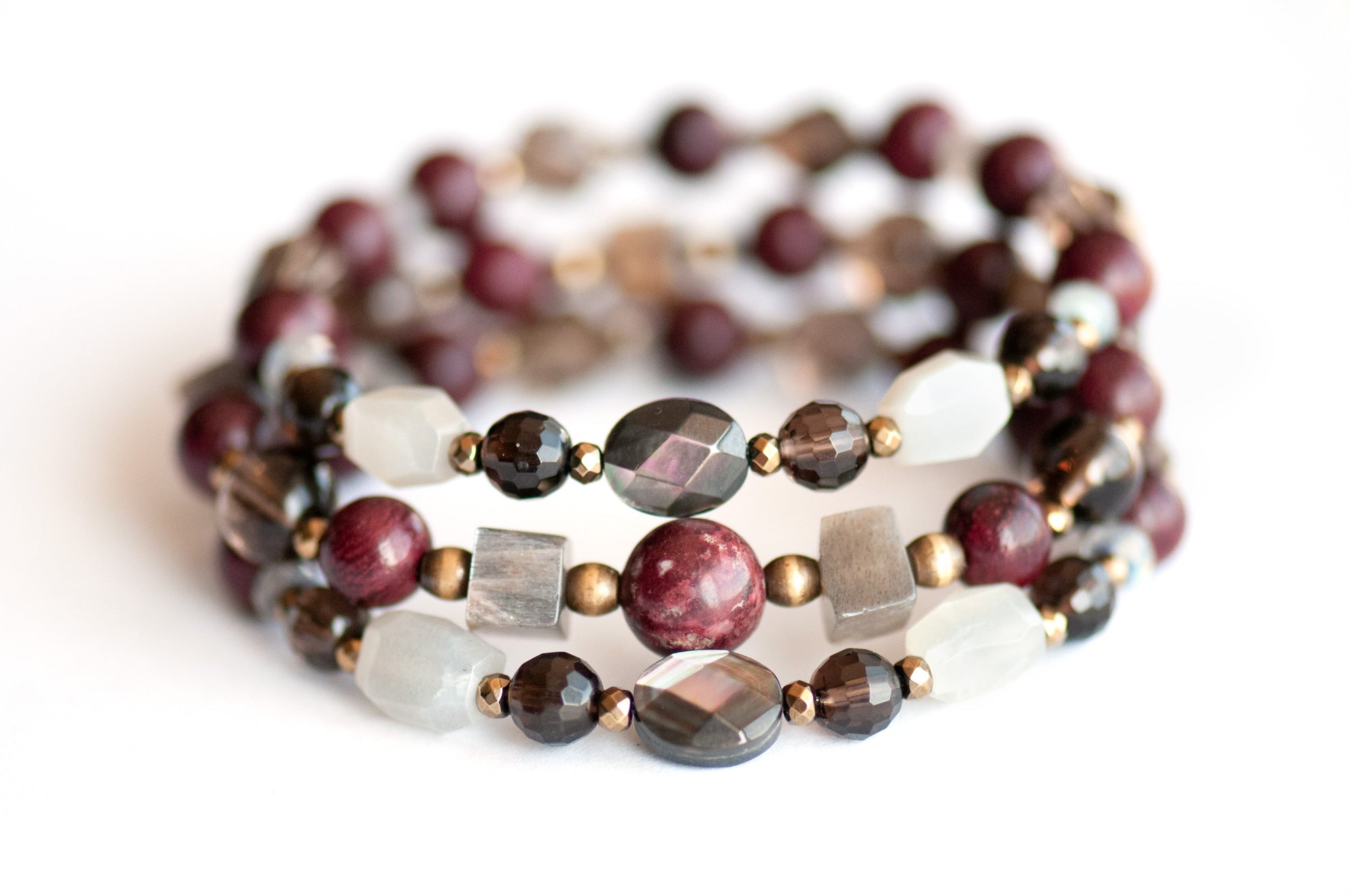 Handcrafted Morrigan gemstone bracelet set featuring rare Eudialyte, Grey Moonstone, Smoky Quartz, Labradorite, and Purpleheart Wood beads