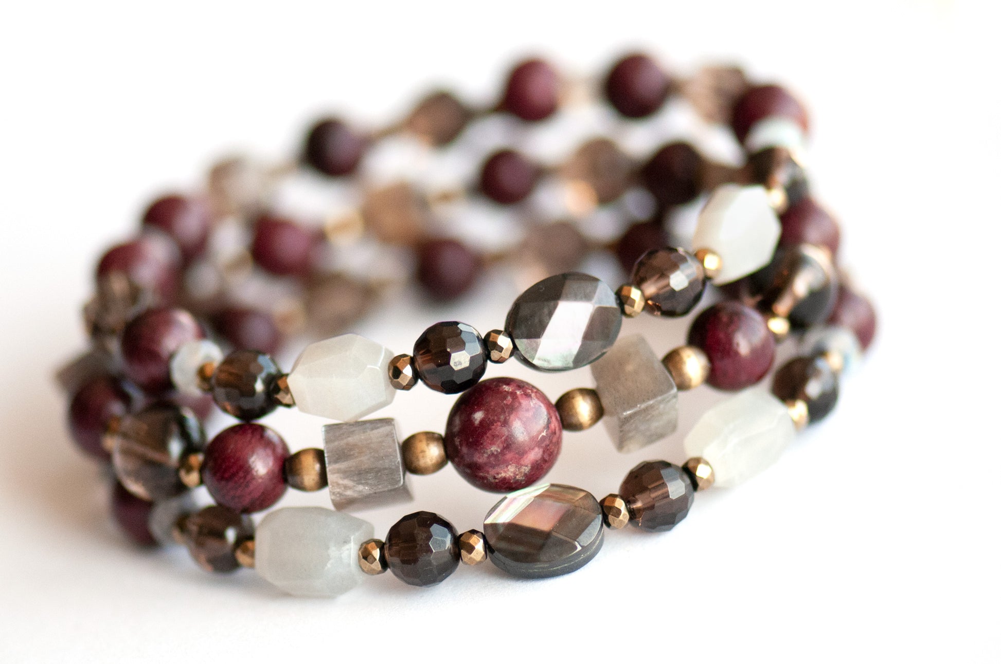 Handcrafted Morrigan gemstone bracelet set featuring rare Eudialyte, Grey Moonstone, Smoky Quartz, Labradorite, and Purpleheart Wood beads