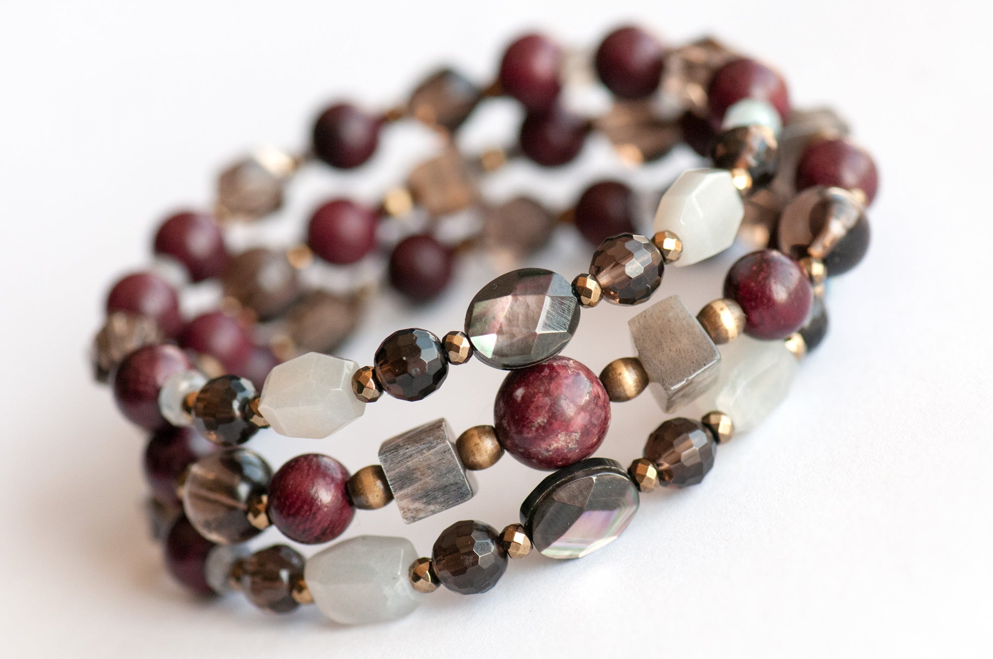 Handcrafted Morrigan gemstone bracelet set featuring rare Eudialyte, Grey Moonstone, Smoky Quartz, Labradorite, and Purpleheart Wood beads