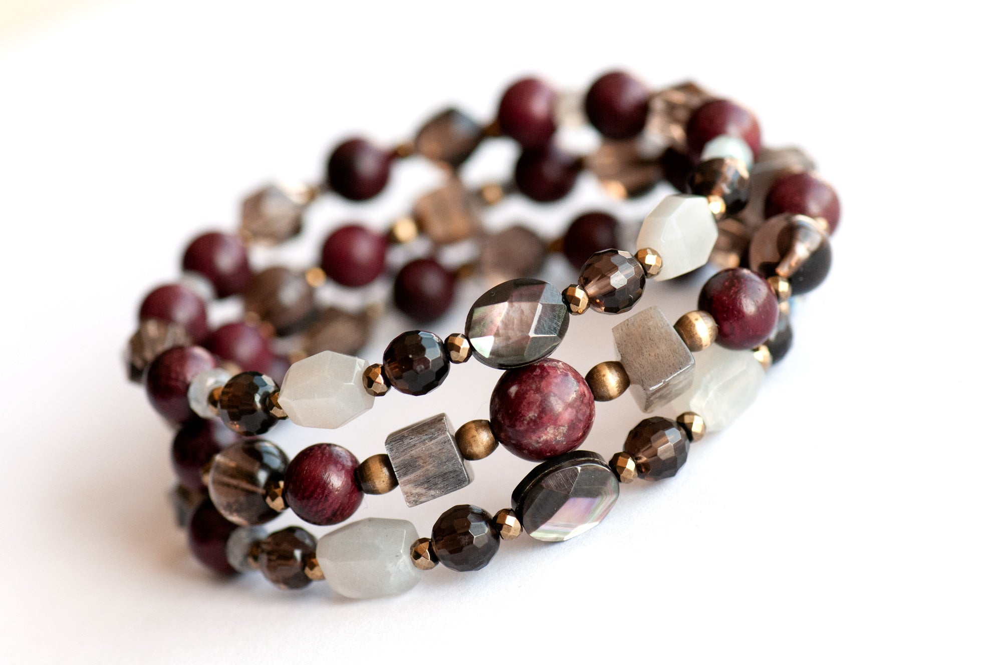 Handcrafted Morrigan gemstone bracelet set featuring rare Eudialyte, Grey Moonstone, Smoky Quartz, Labradorite, and Purpleheart Wood beads