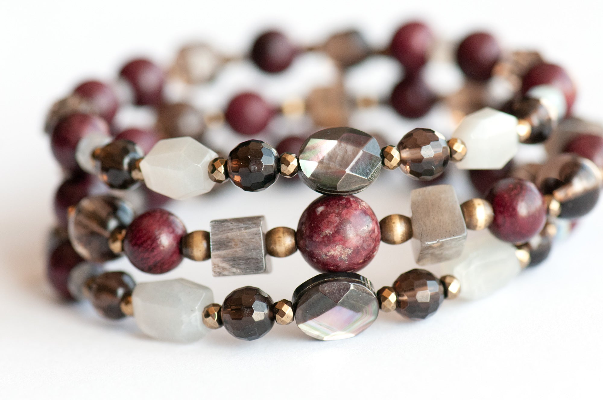 Handcrafted Morrigan gemstone bracelet set featuring rare Eudialyte, Grey Moonstone, Smoky Quartz, Labradorite, and Purpleheart Wood beads