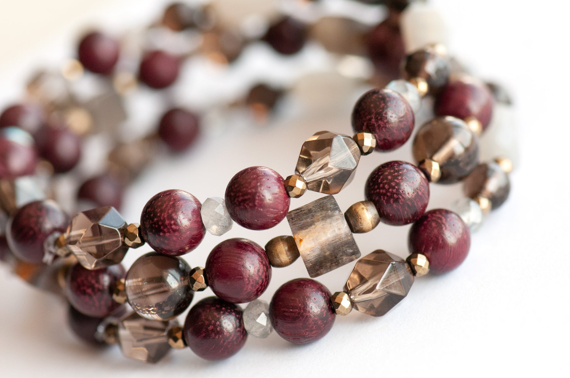 Handcrafted Morrigan gemstone bracelet set featuring rare Eudialyte, Grey Moonstone, Smoky Quartz, Labradorite, and Purpleheart Wood beads