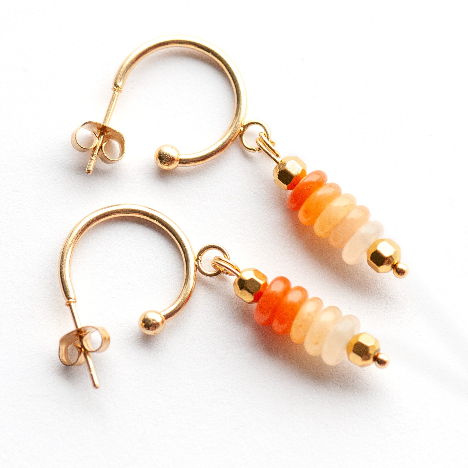 Elegant sunrise-inspired earrings with ombré Orange Aventurine and gold-plated accents. Lightweight half-hoop design for a warm, uplifting everyday look.