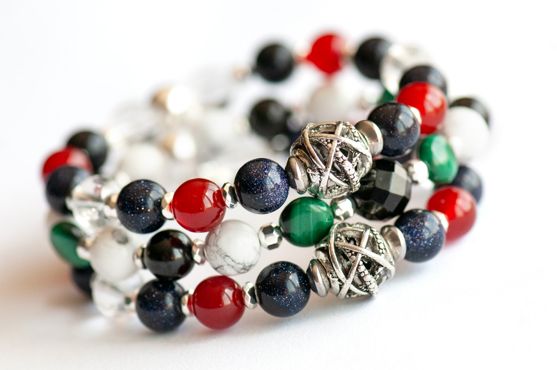 Art Deco Lynx bracelet stack featuring Onyx, Malachite, and Hematite with geometric silver accents