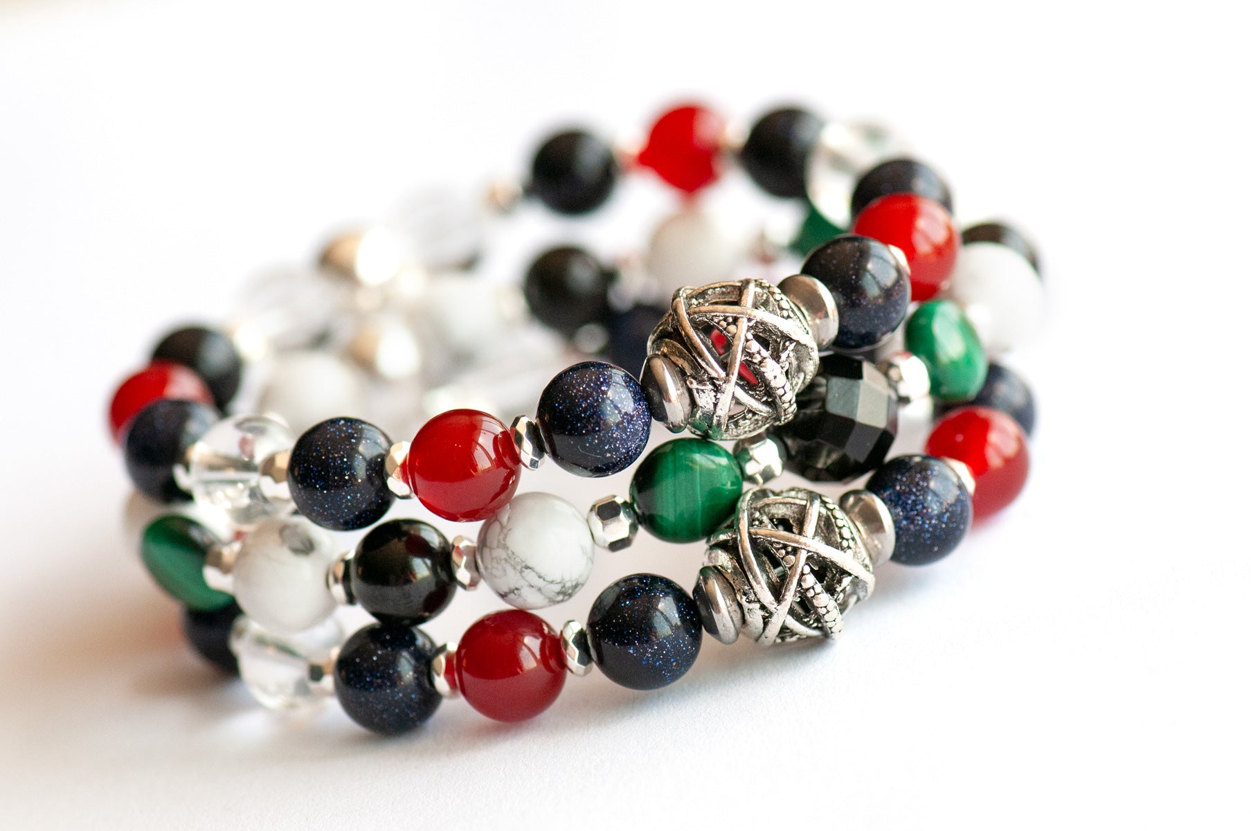 Art Deco Lynx bracelet stack featuring Onyx, Malachite, and Hematite with geometric silver accents