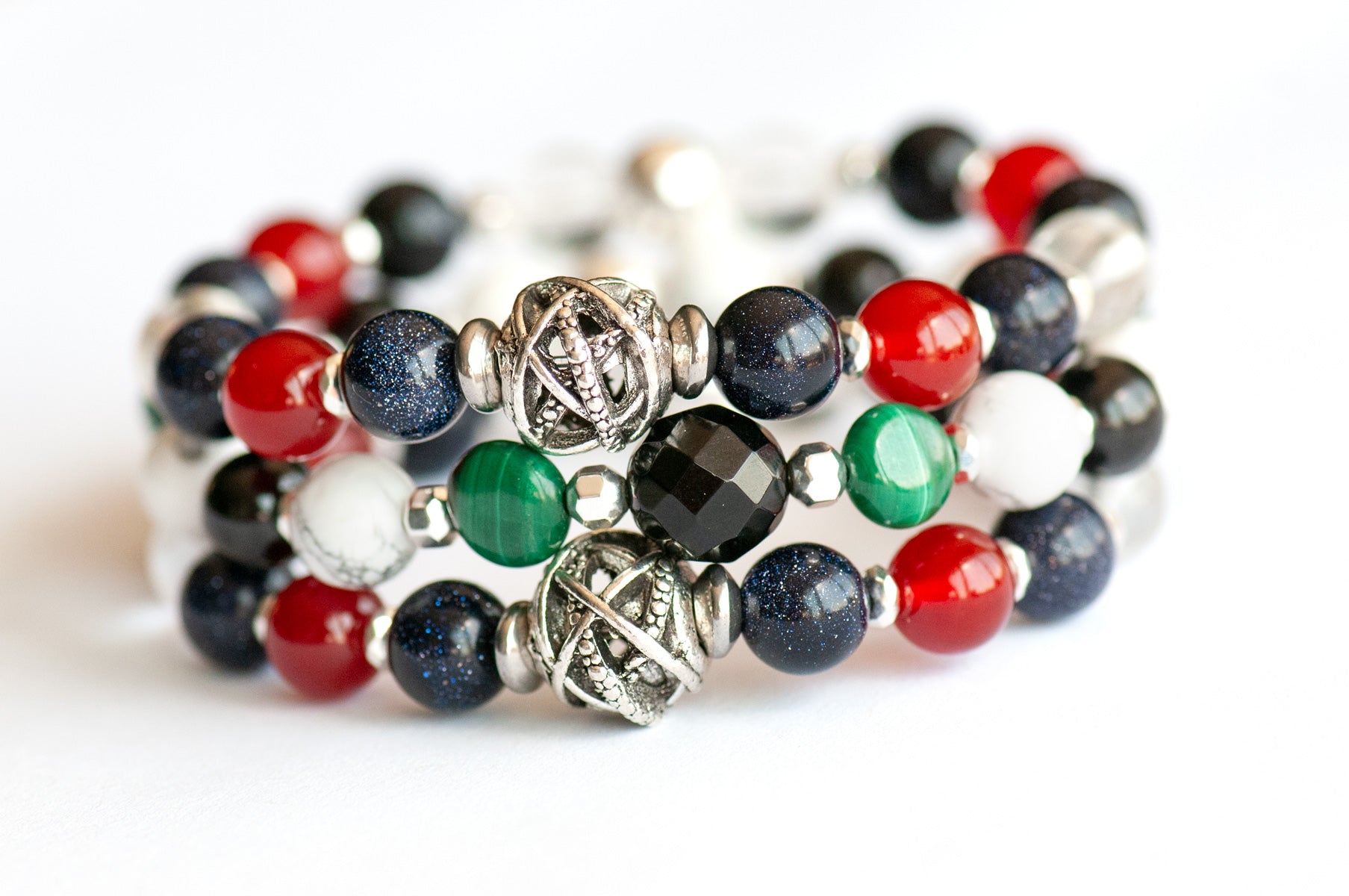 Art Deco Lynx bracelet stack featuring Onyx, Malachite, and Hematite with geometric silver accents