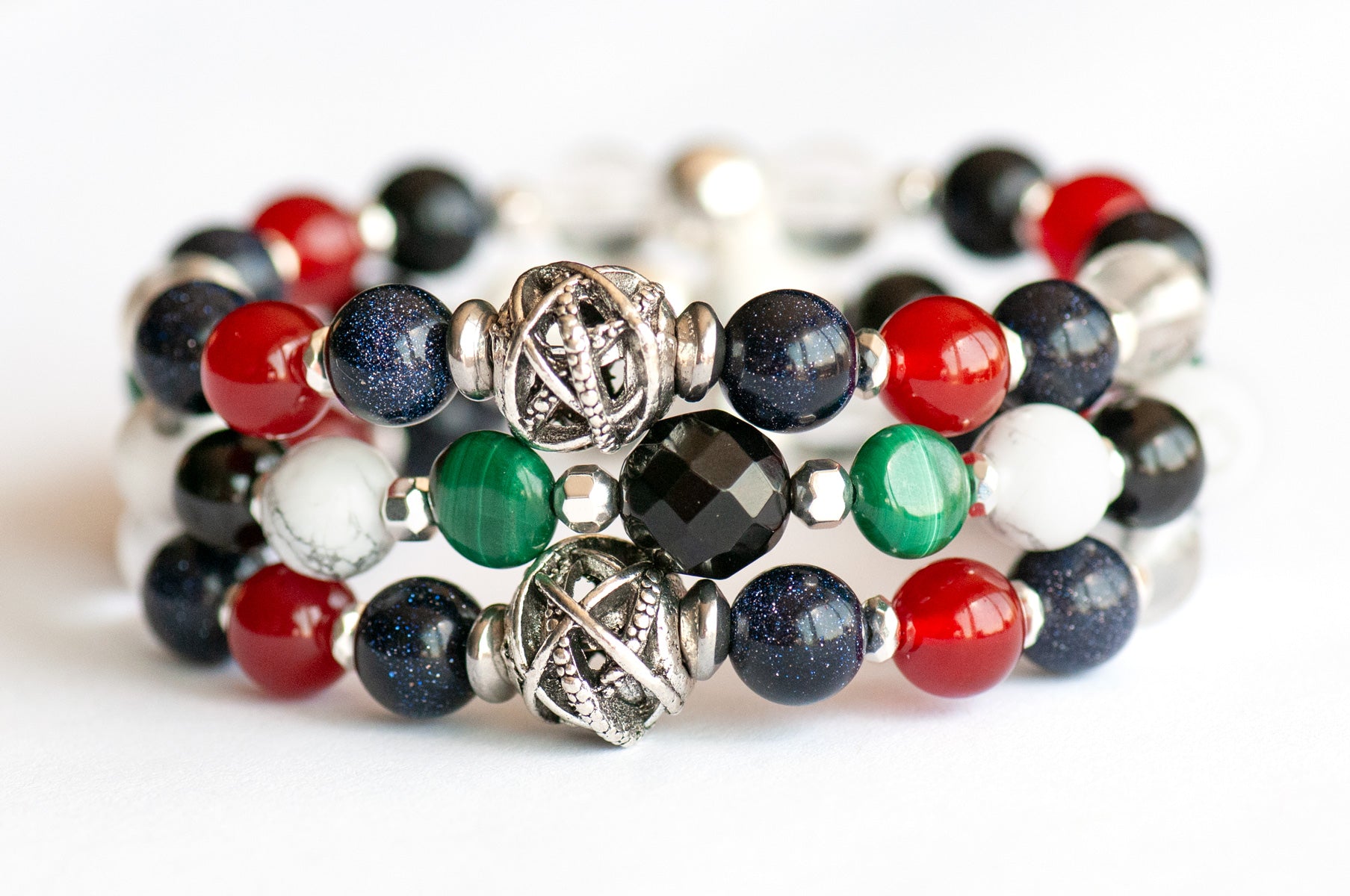 Art Deco Lynx bracelet stack featuring Onyx, Malachite, and Hematite with geometric silver accents