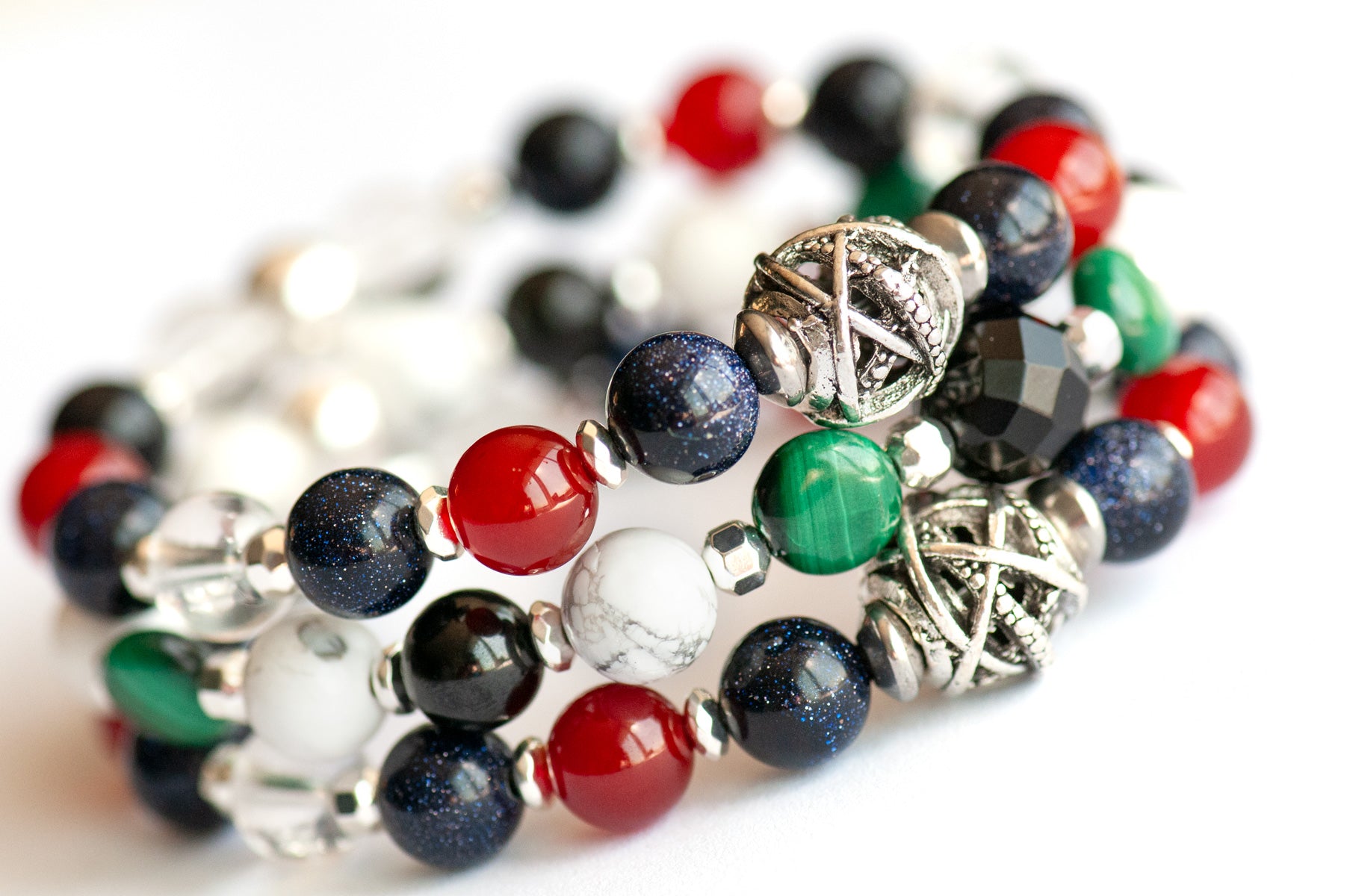 Art Deco Lynx bracelet stack featuring Onyx, Malachite, and Hematite with geometric silver accents