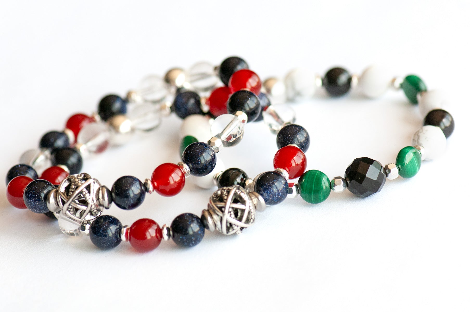 Art Deco Lynx bracelet stack featuring Onyx, Malachite, and Hematite with geometric silver accents