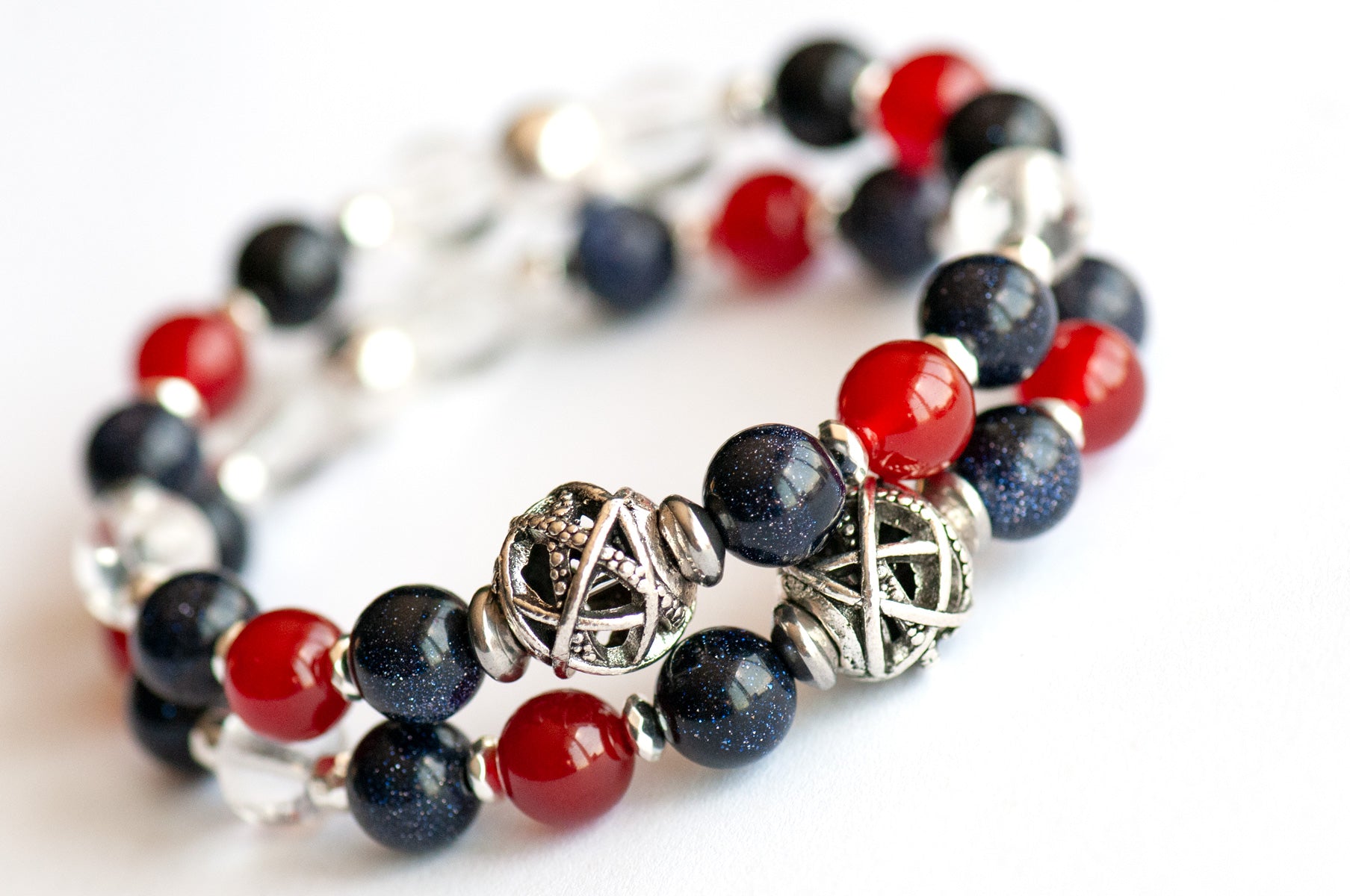 Supporting bracelets in Art Deco Lynx set showing Blue Goldstone, Carnelian, Crystal Quartz, and silver focal beads