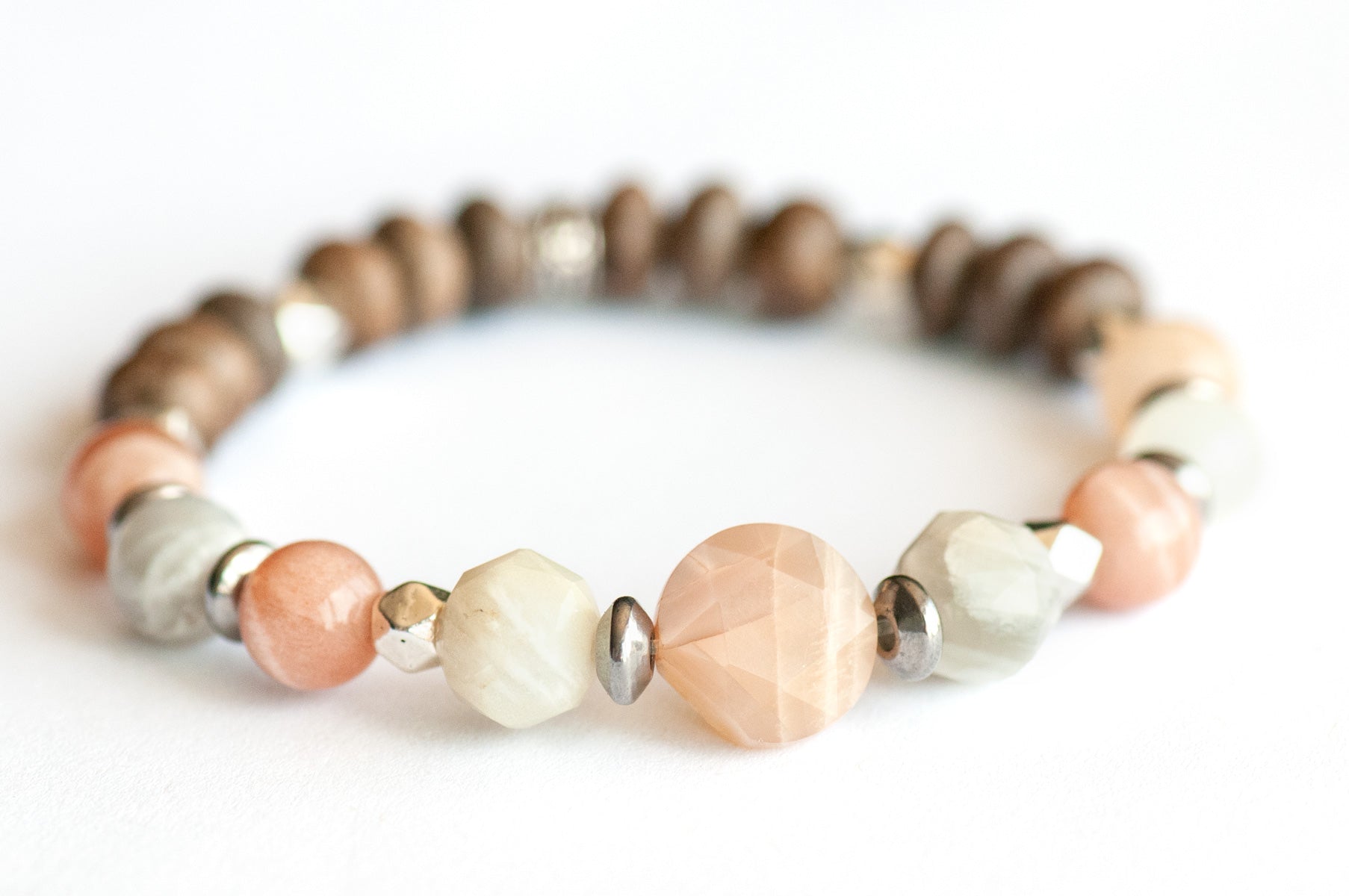 Feature bracelet from Nova Scotia Lynx Set – Mixed Moonstone star-cut coin, rounds, and faceted beads with grey wood rondelles and silver spacers