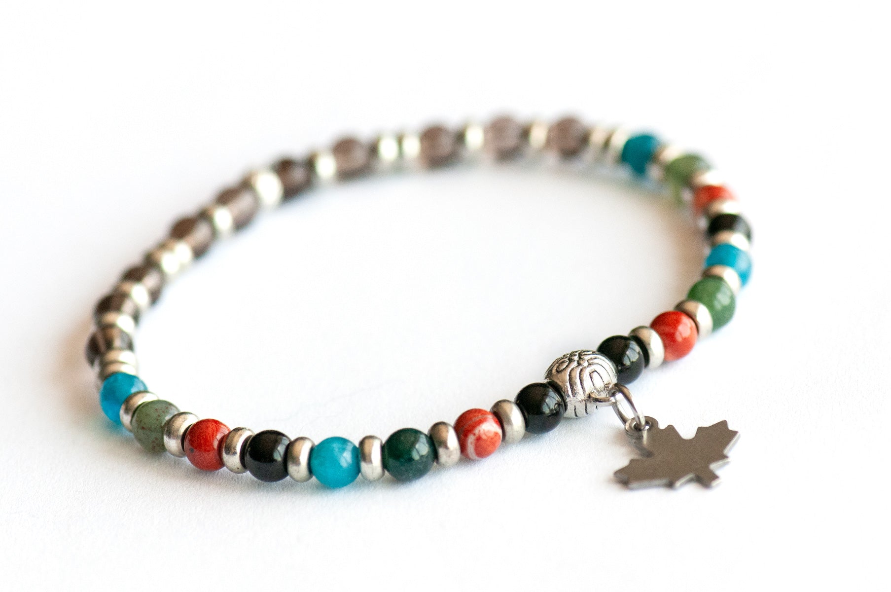 Supporting bracelet from New Brunswick Lynx Set – 4mm round stones with charm, including Black Tourmaline, Red Jasper, Moss Agate, Blue Apatite, and Smoky Quartz