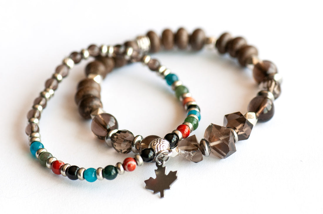 Two coordinating handmade gemstone bracelets with Smoky Quartz, wood beads, and a charm-accented stacker
