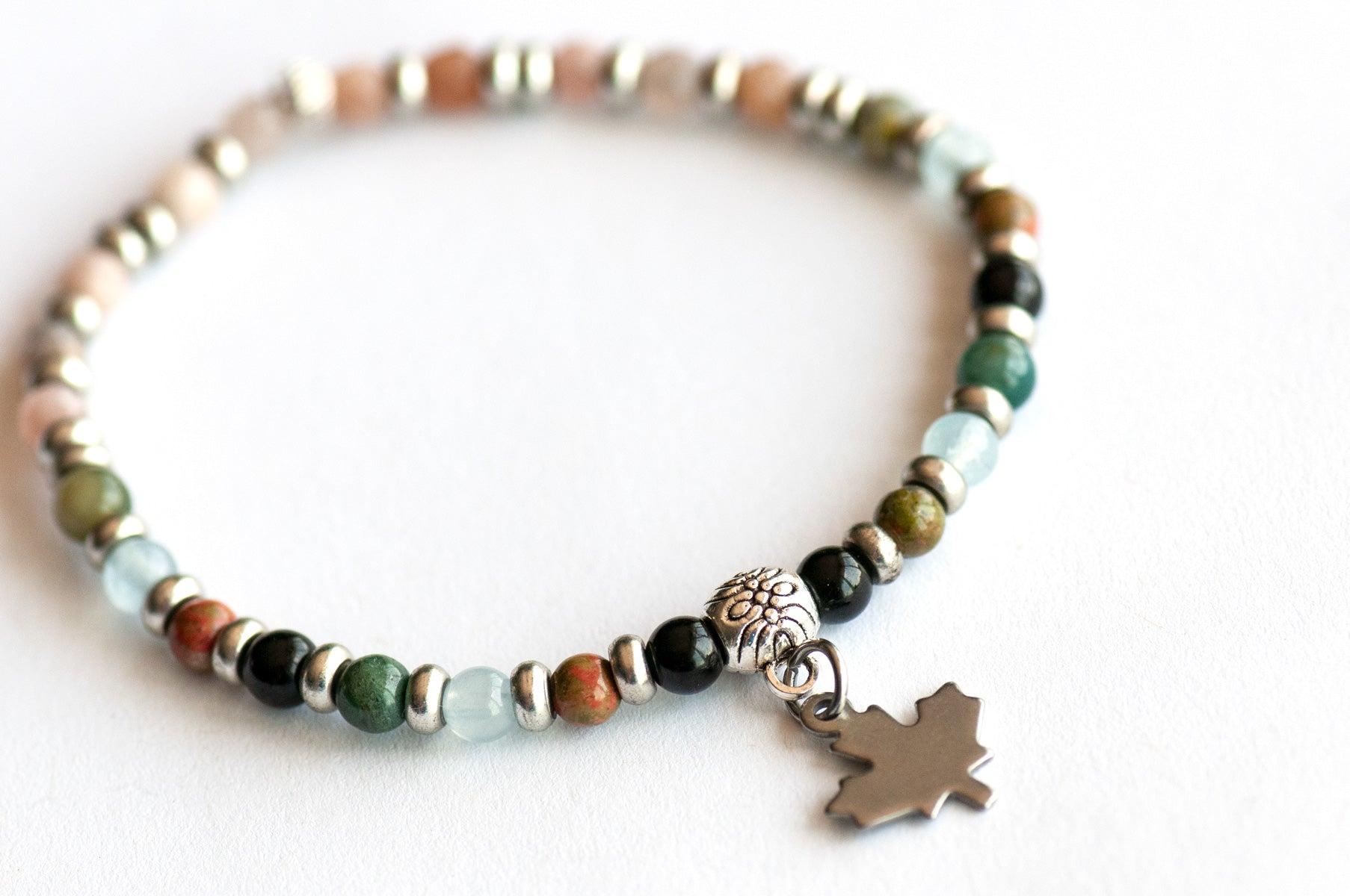 Supporting bracelet from Nova Scotia Lynx Set – 4mm round stones with charm, including Black Tourmaline, Unakite, Moss Agate, Aquamarine, and Mixed Moonstone
