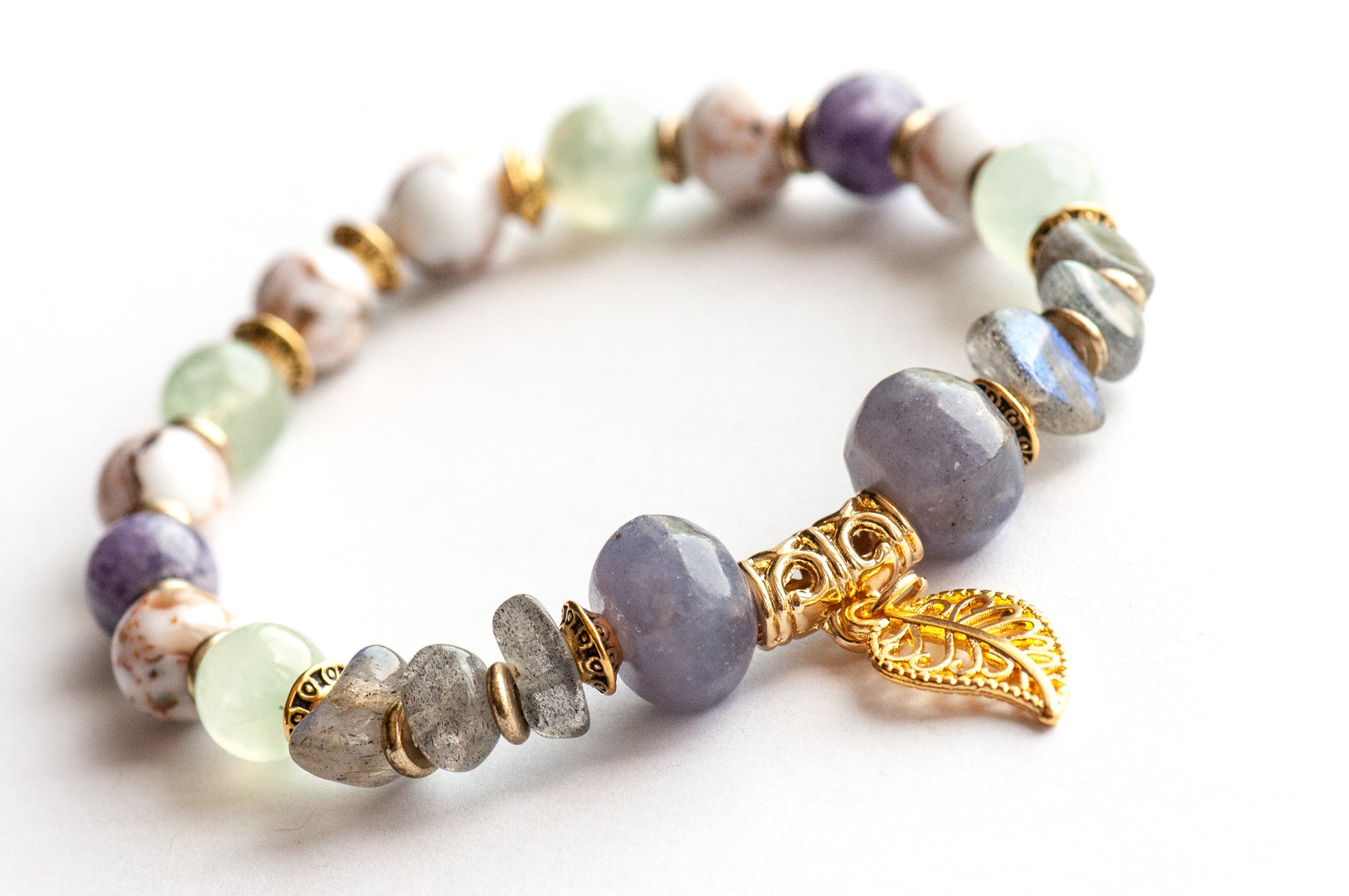 Close-up of Art Nouveau Lynx focal bracelet with gold leaf, Lepidolite rondelles, and Labradorite chips